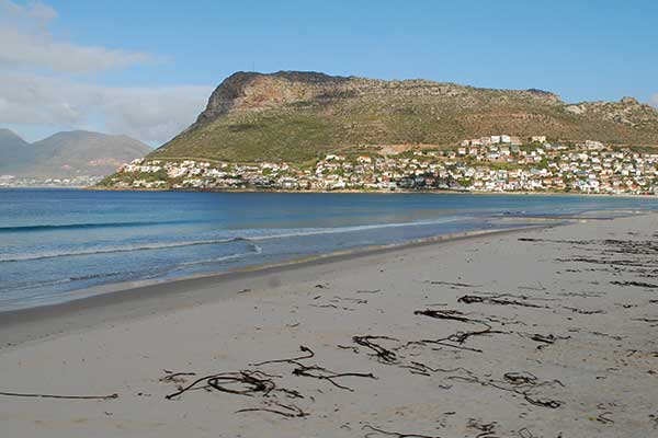 Fish Hoek Beach in Cape Town with long sandy shoreline and False Bay mountains