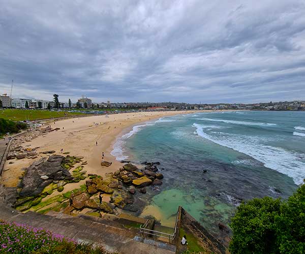 Bondi Beach Sydney with surfers and golden sand