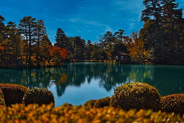 Shugakuin Imperial Villa garden in Kyoto with pond, trees and mountain scenery